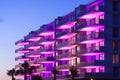 an apartment building with purple lights on the balconies Royalty Free Stock Photo