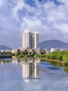 Apartment building reflected in a river on a summer day, Sanya, Hainan Island, China