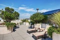 Apartment building roof top terrace exterior with lounge chairs Royalty Free Stock Photo