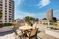 Apartment building roof top terrace exterior with patio table set Royalty Free Stock Photo