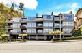 Apartment building with walkway with brenches.