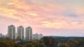 Apartment buildings at sunset. Colorful evening dusky sky high-rise buildings residential area silhouettes over forests Royalty Free Stock Photo