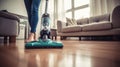 Apartment cleaning in progress as women\'s feet handle the vacuum