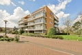 an apartment building with a brick driveway and a lawn Royalty Free Stock Photo