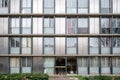 an apartment complex with various levels of windows and walkway in front of it