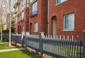 Apartment house, residential building complex with gate. Exterior of a house with front door and wooden fence and gate Royalty Free Stock Photo