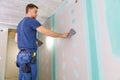 apartment interior construction - worker plastering gypsum board