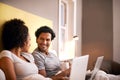 Apartment, laptop and couple with smile for working from home in bedroom, eye contact and together with love. Partners Royalty Free Stock Photo