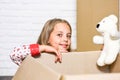 Apartment Living. happy child cardboard box. repair of room. new apartment. happy little girl with toy. purchase of new Royalty Free Stock Photo