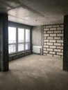 The apartment in the new building with a free layout without repair and decoration with bare walls a large panoramic French window