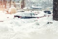 Apartment or office building parking lot with many cars covered by snow stucked after heavy blizzard snowfall on winter Royalty Free Stock Photo