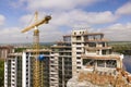 Apartment or office tall building under construction. Brick walls, glass windows, scaffolding and concrete support pillars. Tower Royalty Free Stock Photo