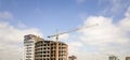 Apartment or office tall building under construction. Brick walls, glass windows, scaffolding and concrete support pillars. Tower Royalty Free Stock Photo