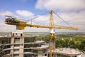 Apartment or office tall building under construction. Brick walls, glass windows, scaffolding and concrete support pillars. Tower Royalty Free Stock Photo