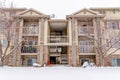 Apartment on a snowy winter setting with stairs and balconies at the facade Royalty Free Stock Photo