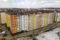 Apartment tall building complex on street corner, top view on bright blue sky copy space background, city landscape stretching to