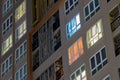 Apartment windows at night in the city with lots of towers and h