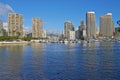 Apartments or business districts beside a harbour on a sunny day with a cloudy blue sky. A popular summer vacation Royalty Free Stock Photo