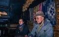 Apatani tribal couple at their home near fire place cooking food at evening from flat angle