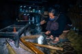 Apatani tribal lady making tea at her home near fire place at evening