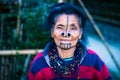 Apatani tribal women facial expression with her traditional nose lobes and blurred background