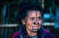 Apatani tribal women facial expression with her traditional nose lobes and blurred background image is taken at ziro arunachal