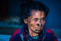 Apatani tribal women facial expression with her traditional nose lobes and blurred background