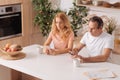 Apathetic mature couple starring at smartphones at home