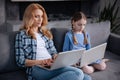 Apathetic mother and little daughter surfing the Internet indoors Royalty Free Stock Photo