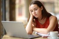 Apathetic student watching online content on laptop