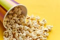 {apecup bucket with spilled popcorn on yellow Royalty Free Stock Photo