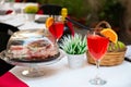 Aperitif in Italy. Delicious tasty traditional italian food and drink. Prosciutto, cheese, olives and cocktail in outdoor Royalty Free Stock Photo