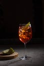 Aperol Spritz cocktail with prosecco, aperitif and soda water and slice of lemon on black background Royalty Free Stock Photo