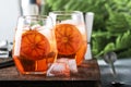 Aperol spritz cocktail in wine glass with sparkling wine, liqueur, ice cubes and red orange - summer Italian low alcohol cold Royalty Free Stock Photo