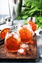 Aperol spritz cocktail in wine glass with sparkling wine, liqueur, ice cubes and red orange - summer Italian low alcohol cold Royalty Free Stock Photo