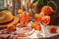 aperol spritz cocktails and sun hats on table