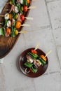 Apetizers on wooden skewers. Snacks from mozzarella, cherry tomatoes, salmon, spinach and olives.