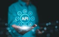 API, Application Programming Interface Concept. A person presents a glowing API Royalty Free Stock Photo