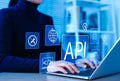API Application Programming Interface Concept. A person types on laptop, with digital icons representing API development, security Royalty Free Stock Photo