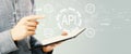 API - application programming interface concept with young man holding a tablet Royalty Free Stock Photo