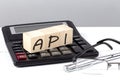 API concept on wooden cubes on calculator on white background Royalty Free Stock Photo