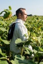 apiarist in beekeeping suit standing in