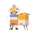 Apiarist at hive, holding honeycomb. Beekeeper in suit hat at beehive with honey comb. Bee keeper worker at apiary Royalty Free Stock Photo