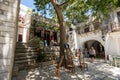 Apiranthos, Naxos / Greece - July 13, 2019: Toutists visiting the narrow streets and shops of Apiranthos Royalty Free Stock Photo