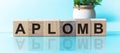 APLOMB word made with building blocks, blu background Royalty Free Stock Photo