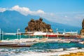 Apo island, Philippines, view on island beach line. Palm trees, rocks, sea and boats.