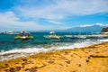 Apo island, Philippines, view on island beach line. Palm trees, rocks, sea and boats.