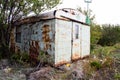 Apocalypse concept photo. Doomsday Post-Apocalyptic Abandoned House. Old metal wagon of apocalyptic appearance. View of the land a