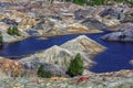 Apocalyptic landscape like a planet Mars surface. Fantastic view of blue lake. Solidified red-brown black Earth surface. Barren, Royalty Free Stock Photo