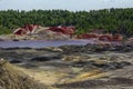 Apocalyptic landscape like a planet Mars surface. Fantastic view of crimson red lake. Solidified red-brown black Earth surface. Royalty Free Stock Photo